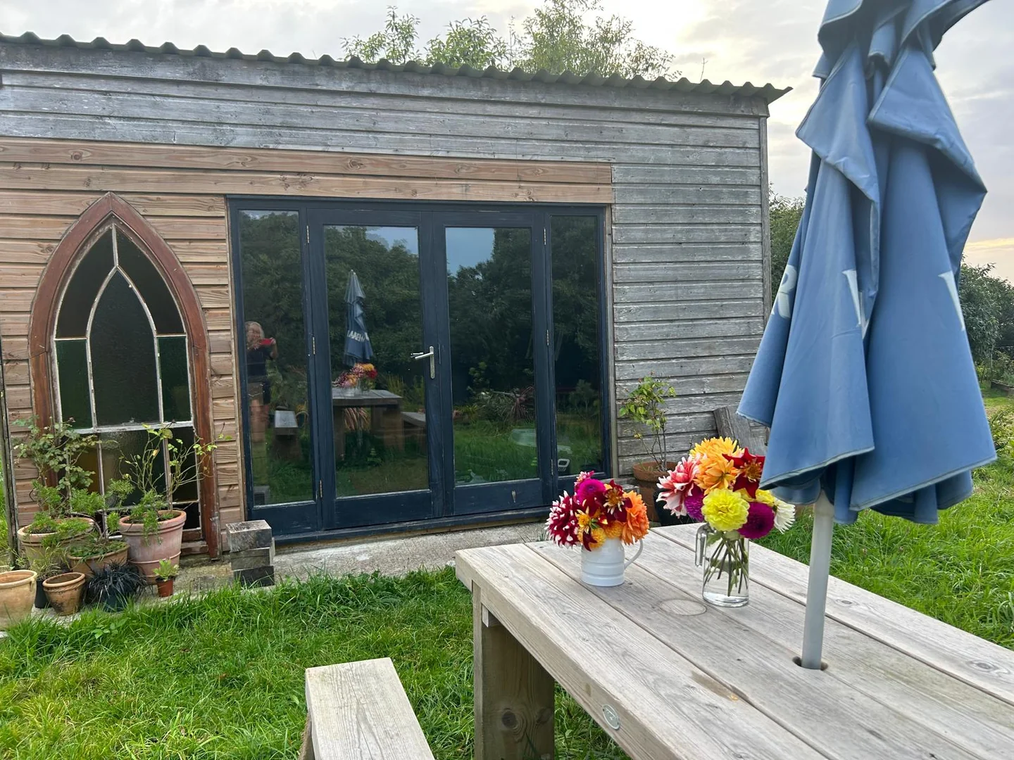 A characterful timber garden room with flowers outside