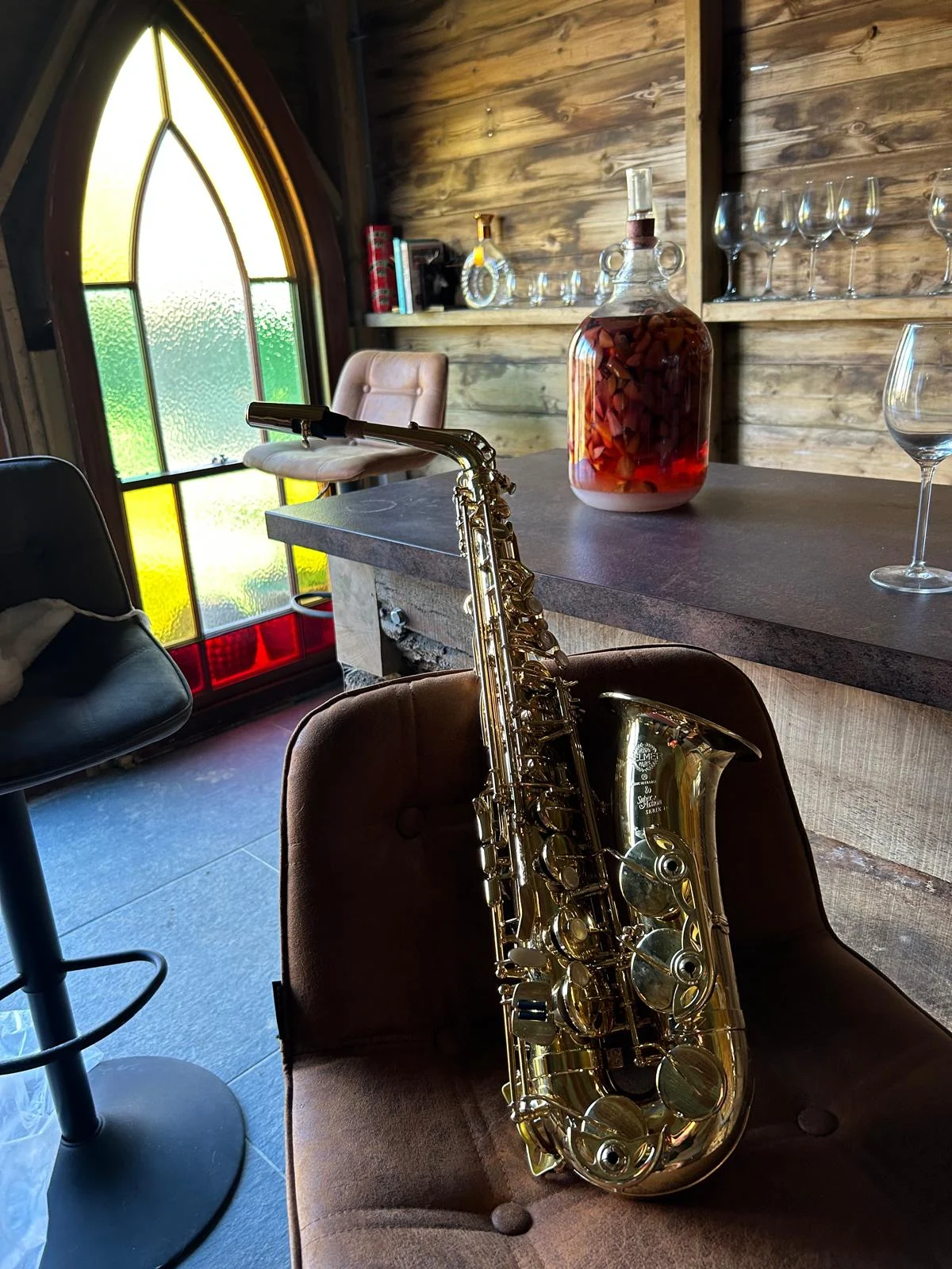 A golden saxophone displayed inside a characterful timber outdoor bar